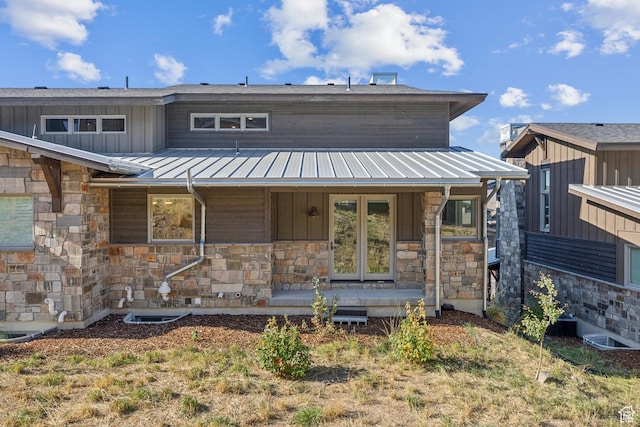 363 E Overlook Loop E Unit 22, Hideout, UT 84036 - view of front of property featuring stone siding, a porch, metal roof, board and batten siding, and a standing seam roof