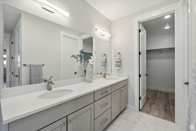 363 E Overlook Loop E Unit 22, Hideout, UT 84036 - full bath featuring double vanity, marble look tile flooring, baseboards, and a walk in closet