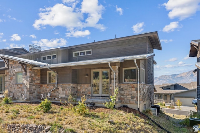 363 E Overlook Loop E Unit 22, Hideout, UT 84036 - view of front of house featuring stone siding, covered porch, a mountain view, and board and batten siding