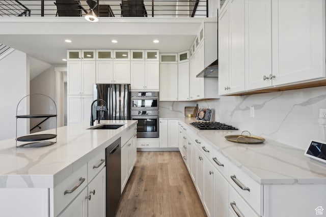 363 E Overlook Loop E Unit 22, Hideout, UT 84036 - kitchen featuring white cabinetry, light wood finished floors, a sink, a large island with sink, and stainless steel appliances
