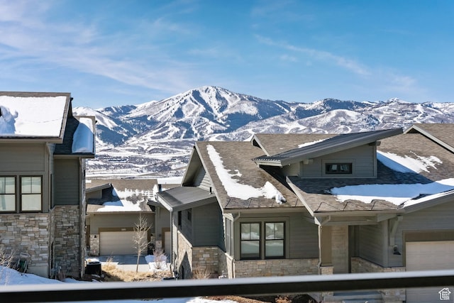 363 E Overlook Loop E Unit 22, Hideout, UT 84036 - view of front of house featuring stone siding, a mountain view, and a garage