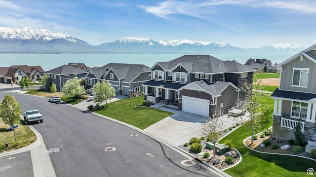 267 E Sandhill Dr, Saratoga Springs, UT 84045 - view of front facade with board and batten siding, driveway, a residential view, and a water and mountain view