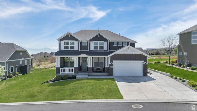 267 E Sandhill Dr, Saratoga Springs, UT 84045 - craftsman-style house featuring covered porch, driveway, board and batten siding, a garage, and a front yard