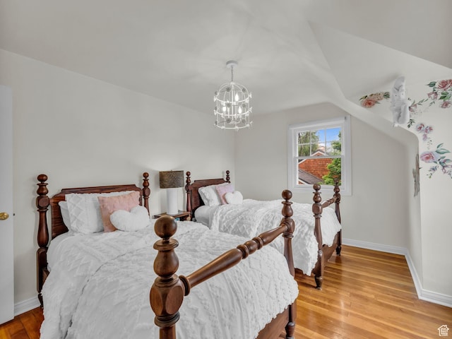 941 S Connor St E, Salt Lake City, UT 84108 - bedroom featuring baseboards, light wood finished floors, and a chandelier