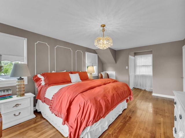 941 S Connor St E, Salt Lake City, UT 84108 - bedroom featuring a chandelier, light wood-type flooring, and baseboards