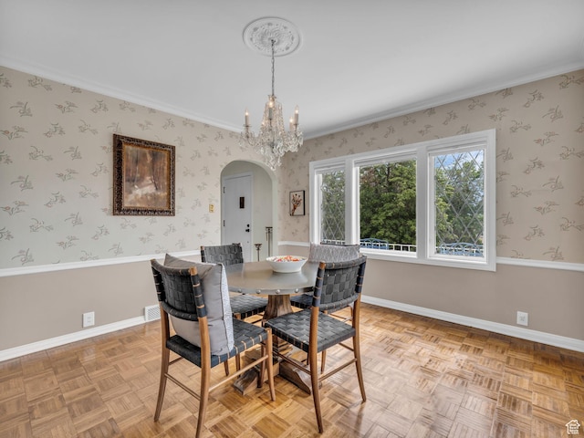 941 S Connor St E, Salt Lake City, UT 84108 - dining space with arched walkways, a chandelier, baseboards, wallpapered walls, and ornamental molding