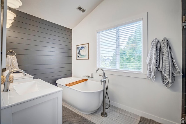88 W 780 S, Centerville, UT 84014 - bathroom with lofted ceiling, wood walls, a freestanding tub, baseboards, and vanity