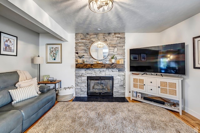88 W 780 S, Centerville, UT 84014 - living room with wood finished floors, a stone fireplace, baseboards, and a textured ceiling