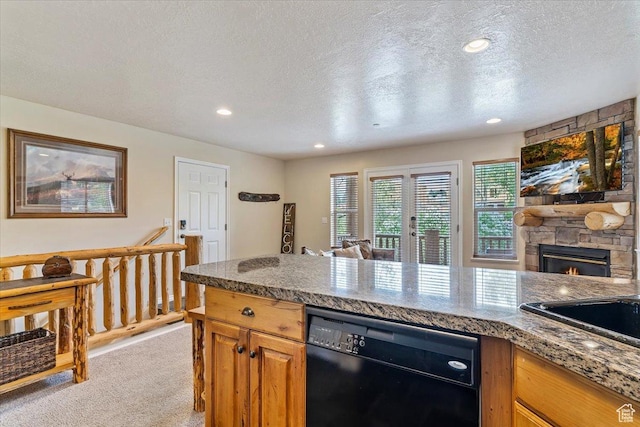 3521 N Fox Run Unit 812, Eden, UT 84310 - kitchen featuring dishwasher, light colored carpet, a textured ceiling, a stone fireplace, and recessed lighting