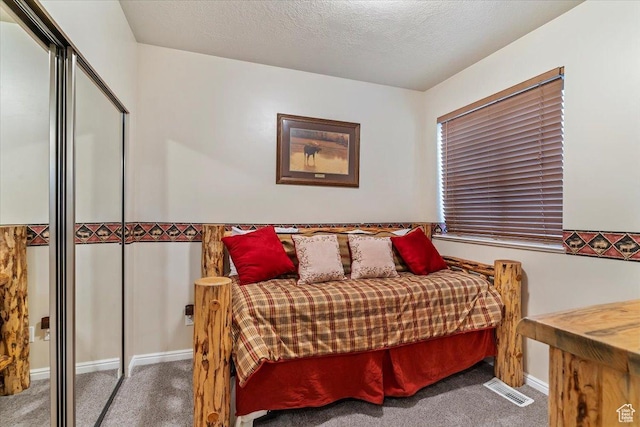 3521 N Fox Run Unit 812, Eden, UT 84310 - bedroom with carpet flooring, baseboards, a textured ceiling, and a closet