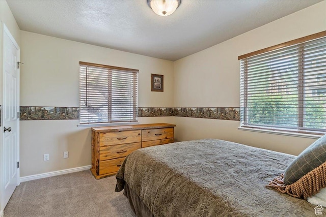 3521 N Fox Run Unit 812, Eden, UT 84310 - bedroom featuring multiple windows, light colored carpet, and baseboards