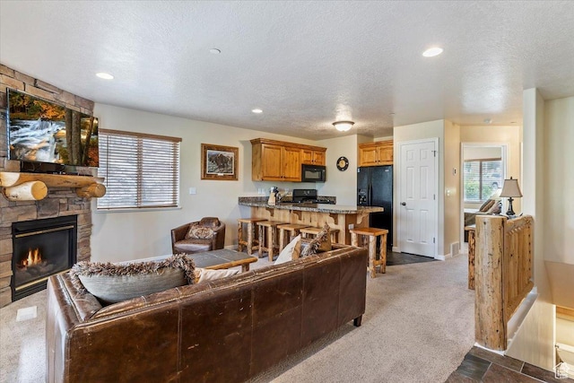 3521 N Fox Run Unit 812, Eden, UT 84310 - living area with a fireplace, a textured ceiling, dark carpet, baseboards, and recessed lighting