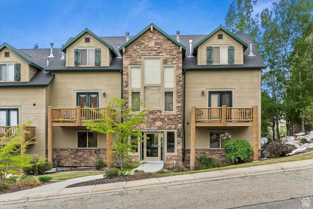 3521 N Fox Run Unit 812, Eden, UT 84310 - view of front of property featuring stone siding, a balcony, and roof with shingles