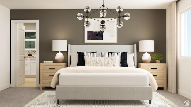 bedroom with carpet floors, baseboards, ensuite bath, and a chandelier