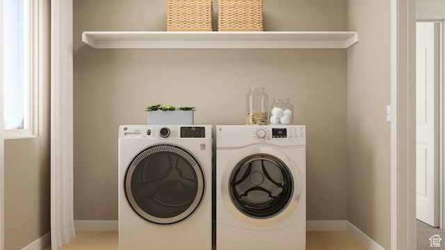 laundry room featuring washer and clothes dryer and baseboards