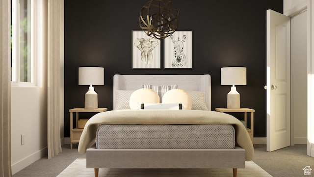 carpeted bedroom featuring a chandelier and baseboards