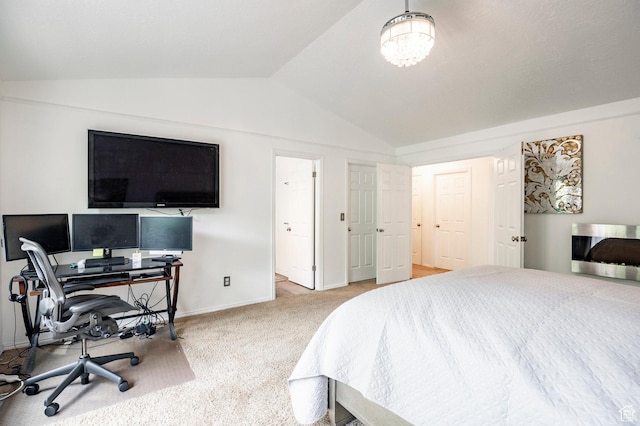 bedroom featuring lofted ceiling, carpet flooring, baseboards, and a desk