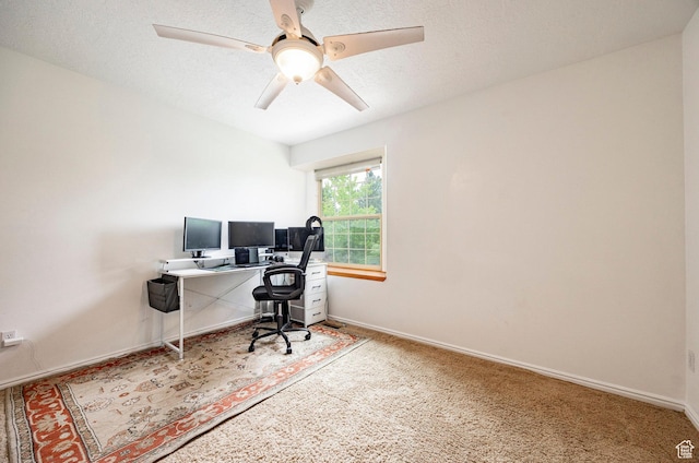 office space with carpet, ceiling fan, and baseboards