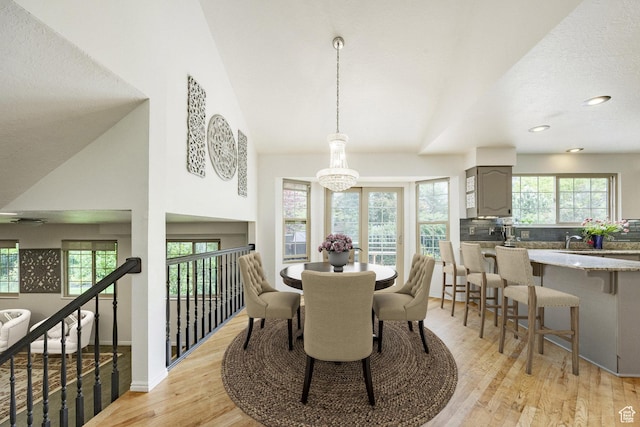 dining area with plenty of natural light, light wood-style flooring, a chandelier, recessed lighting, and baseboards