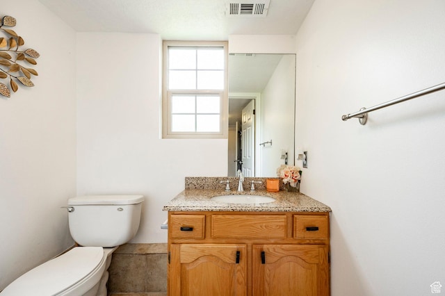 bathroom with toilet and vanity
