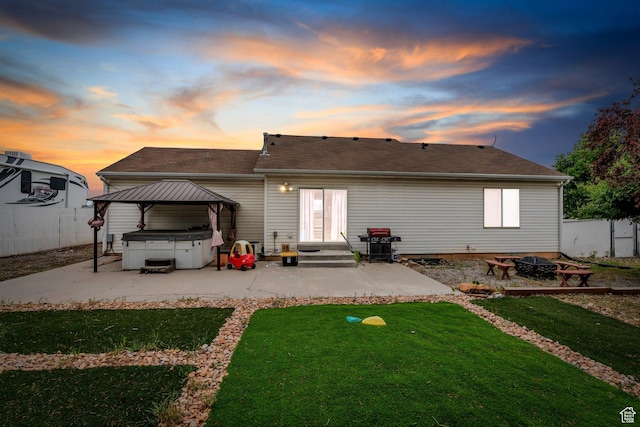 606 N 560 W, Santaquin, UT 84655 - rear view of property featuring a hot tub, a patio area, an outdoor fire pit, a gazebo, and a shingled roof