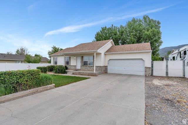 606 N 560 W, Santaquin, UT 84655 - ranch-style home with a garage, driveway, covered porch, brick siding, and a gate