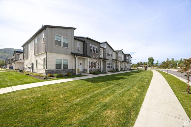 3137 S 225 W Unit 404, Nibley, UT 84321 - multi unit property with board and batten siding, stone siding, a front yard, and a residential view