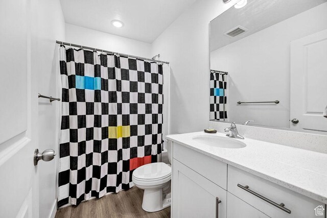 3137 S 225 W Unit 404, Nibley, UT 84321 - full bathroom featuring toilet, vanity, a shower with curtain, and wood finished floors