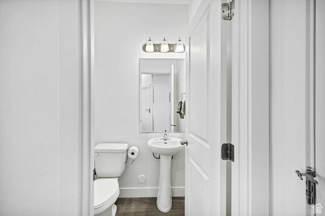 3137 S 225 W Unit 404, Nibley, UT 84321 - bathroom featuring baseboards, toilet, and wood finished floors