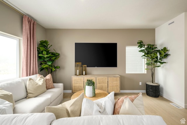 living room featuring light wood-style floors and baseboards