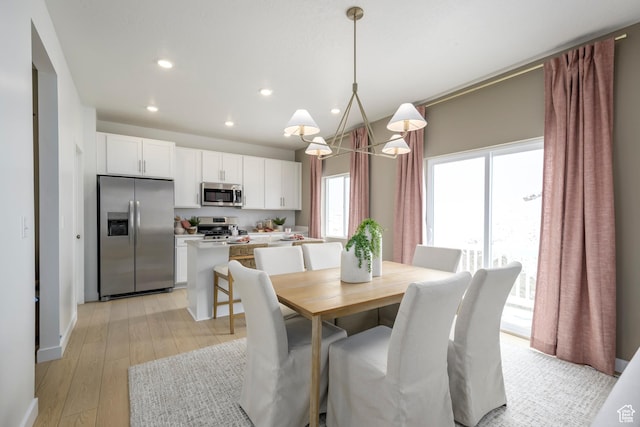 dining room featuring recessed lighting, a chandelier, and light wood-style floors