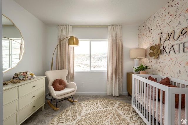 bedroom featuring a crib and carpet flooring