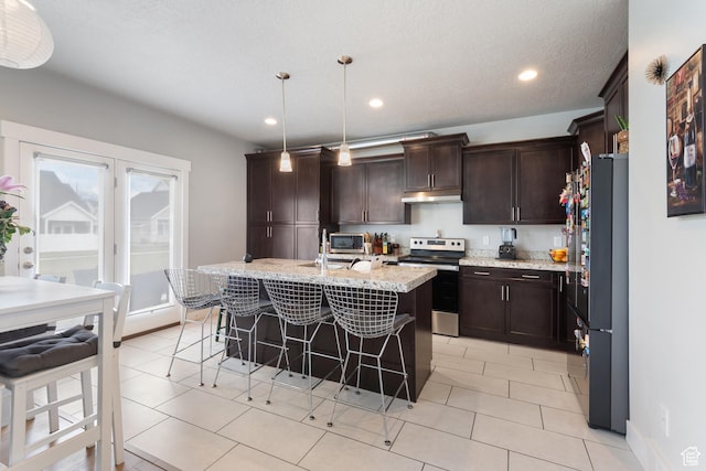 4483 S Parkbury Way, Salt Lake City, UT 84129 - kitchen featuring electric range, freestanding refrigerator, under cabinet range hood, a kitchen breakfast bar, and dark brown cabinets