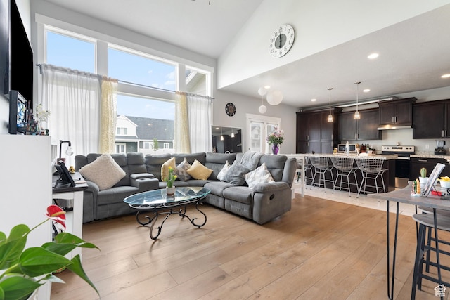 4483 S Parkbury Way, Salt Lake City, UT 84129 - living area with light wood-style flooring, recessed lighting, and a towering ceiling