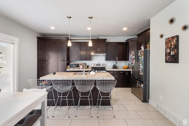 4483 S Parkbury Way, Salt Lake City, UT 84129 - kitchen featuring freestanding refrigerator, a sink, stainless steel range with electric stovetop, dark brown cabinetry, and a breakfast bar