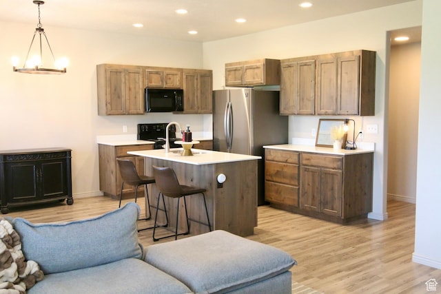 2594 E 600 N, Spanish Fork, UT 84660 - kitchen with black microwave, open floor plan, light countertops, light wood-type flooring, and recessed lighting