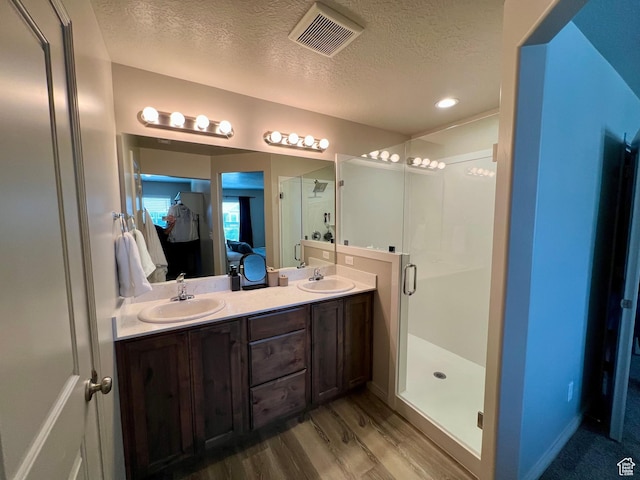 2594 E 600 N, Spanish Fork, UT 84660 - ensuite bathroom featuring a textured ceiling, a shower stall, wood finished floors, double vanity, and recessed lighting