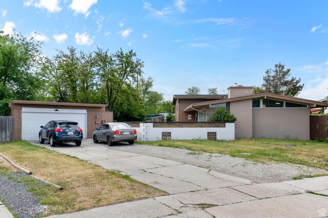 2011 W Todd Way S, Taylorsville, UT 84129 - view of front of house with a chimney, driveway, and a garage