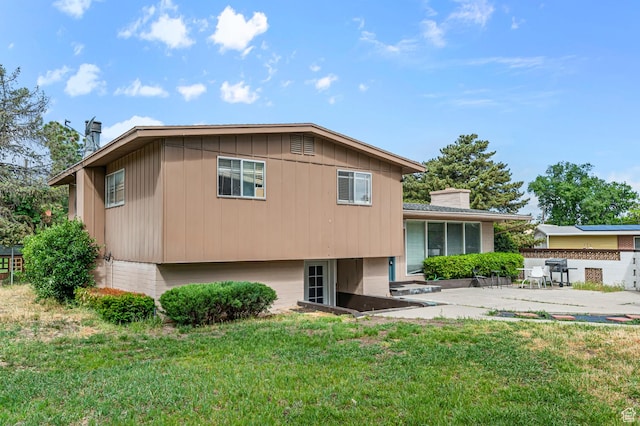 2011 W Todd Way S, Taylorsville, UT 84129 - rear view of house with a patio, a chimney, and board and batten siding