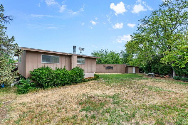 2011 W Todd Way S, Taylorsville, UT 84129 - rear view of house with a lawn and board and batten siding