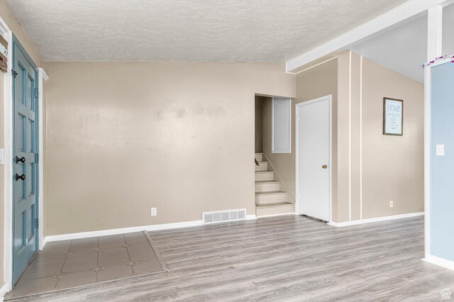 2011 W Todd Way S, Taylorsville, UT 84129 - empty room with a textured ceiling, vaulted ceiling, wood finished floors, stairway, and baseboards