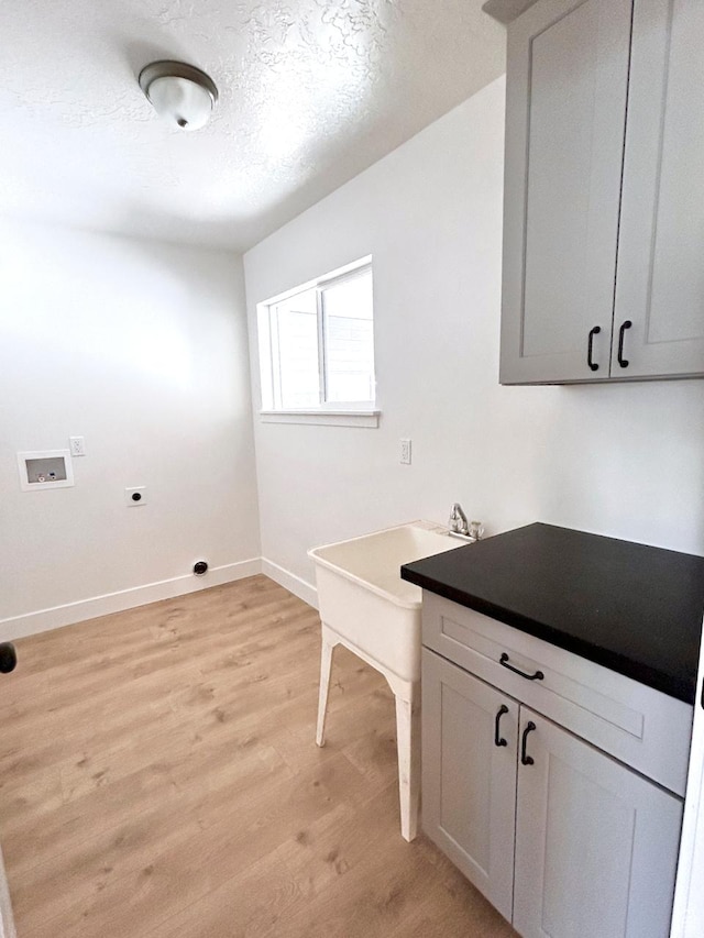 45 E 300 N, Roosevelt, UT 84066 - laundry room with hookup for an electric dryer, washer hookup, light wood-style floors, cabinet space, and a textured ceiling