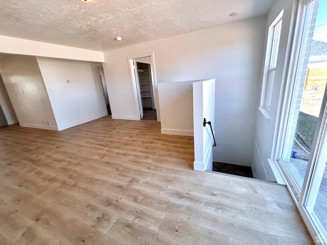 45 E 300 N, Roosevelt, UT 84066 - empty room featuring wood finished floors, healthy amount of natural light, and a textured ceiling