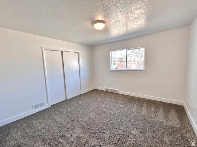 45 E 300 N, Roosevelt, UT 84066 - unfurnished bedroom featuring dark colored carpet, a closet, and a textured ceiling