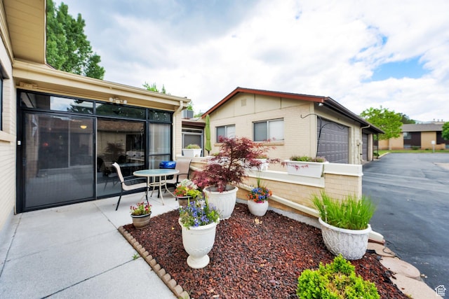 980 E 5475 S, South Ogden, UT 84405 - view of patio featuring a sunroom and a garage
