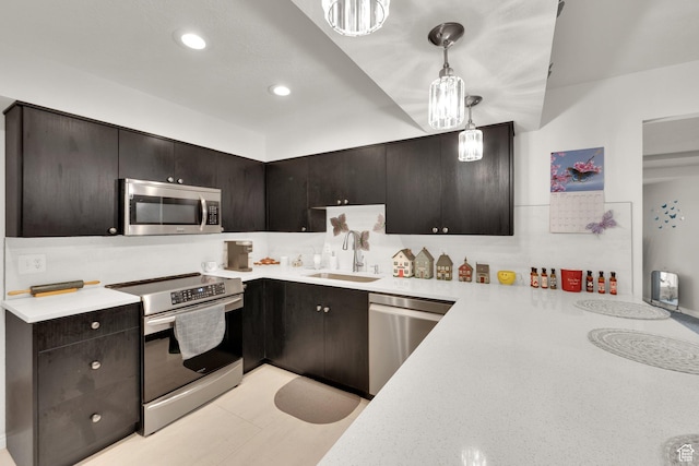 980 E 5475 S, South Ogden, UT 84405 - kitchen with stainless steel appliances, a sink, light countertops, decorative light fixtures, and recessed lighting