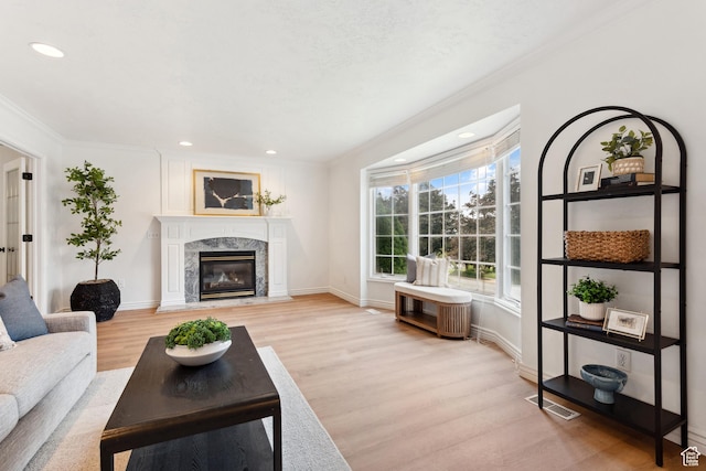 573 S Cherry Ln, Fruit Heights, UT 84037 - living room with light wood-style floors, ornamental molding, recessed lighting, a high end fireplace, and baseboards
