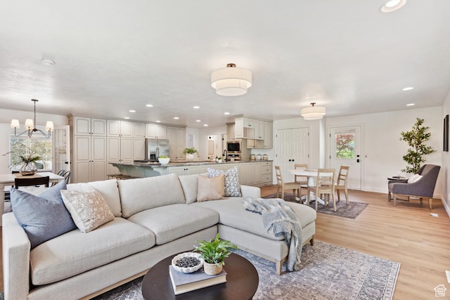 573 S Cherry Ln, Fruit Heights, UT 84037 - living room featuring a chandelier, light wood-type flooring, recessed lighting, and baseboards