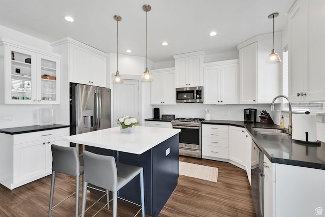 3507 S 4875 W, West Haven, UT 84401 - kitchen with stainless steel appliances, dark countertops, a kitchen island, white cabinetry, and a sink