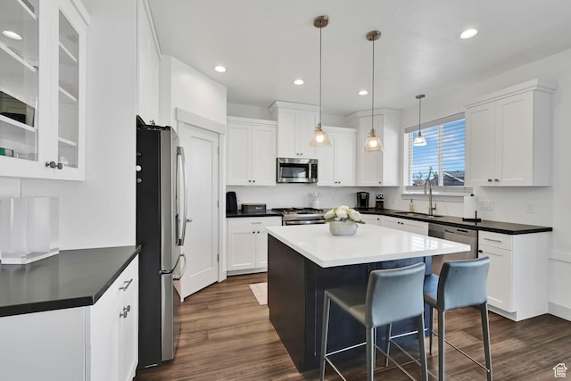 3507 S 4875 W, West Haven, UT 84401 - kitchen with stainless steel appliances, white cabinets, dark wood-style flooring, a kitchen island, and recessed lighting